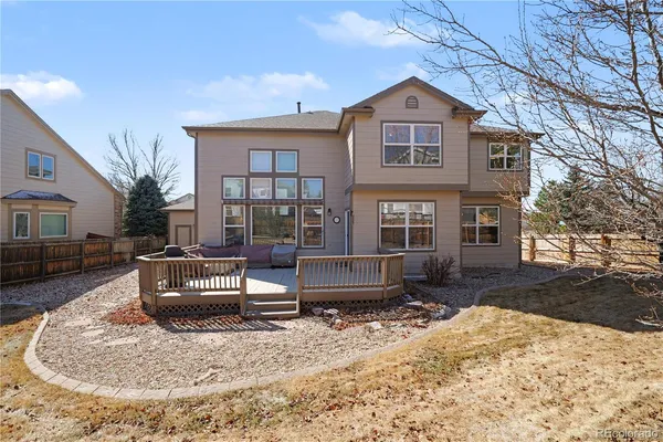 a front view of a house with a yard covered in snow