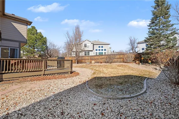 a view of a house with backyard and trees