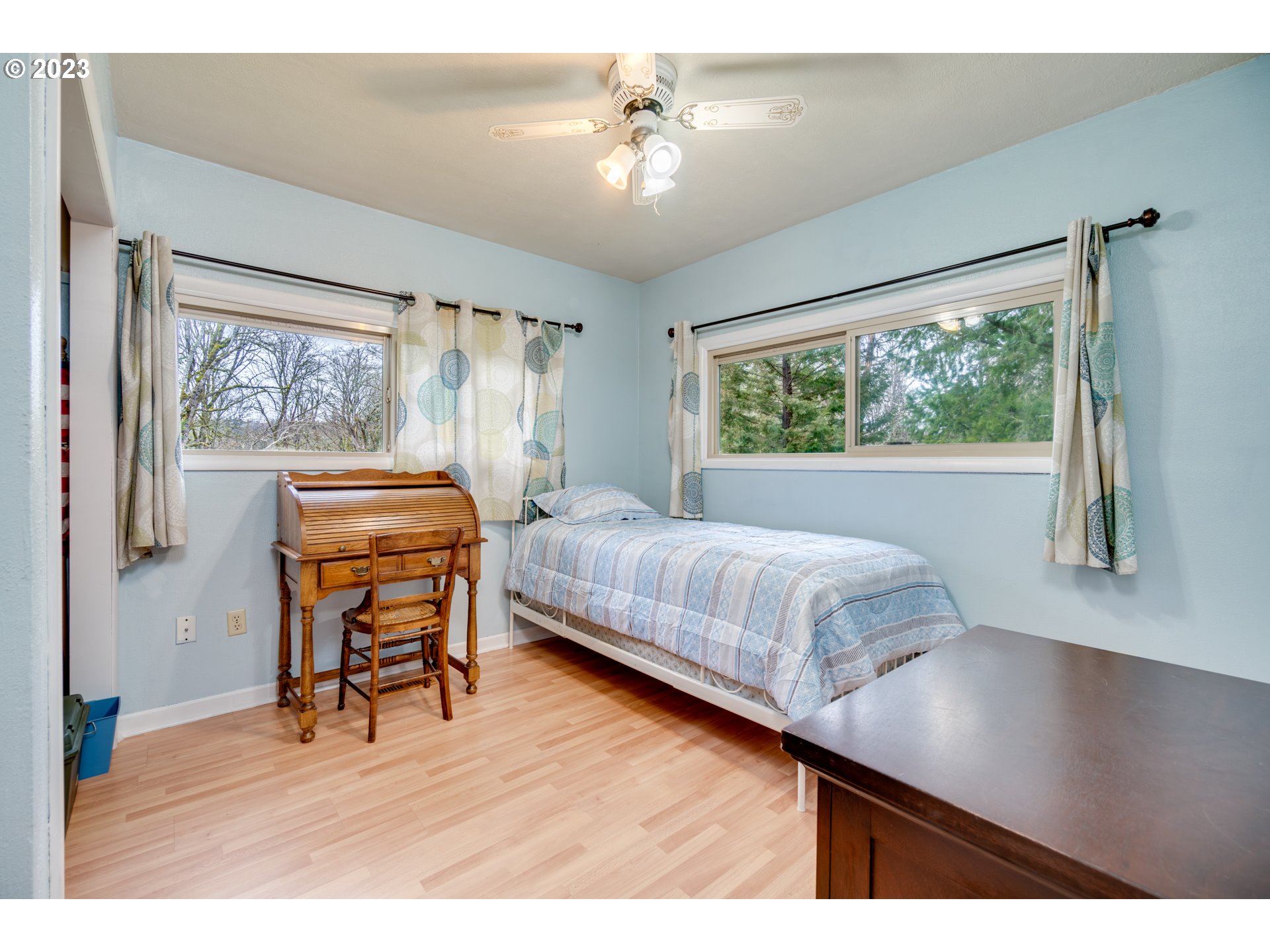 1515 Southeast Northway Road Corbett, OR 97019 - Photo 23 of 32 a bedroom with a bed and a chandelier