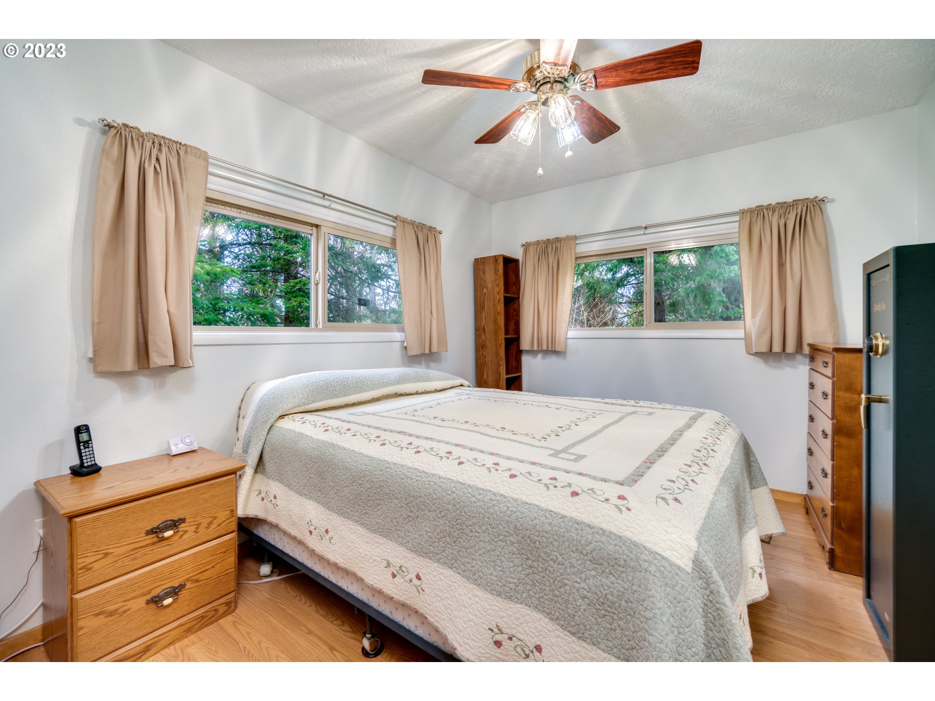 1515 Southeast Northway Road Corbett, OR 97019 - Photo 24 of 32 a bedroom with a bed dresser and a window