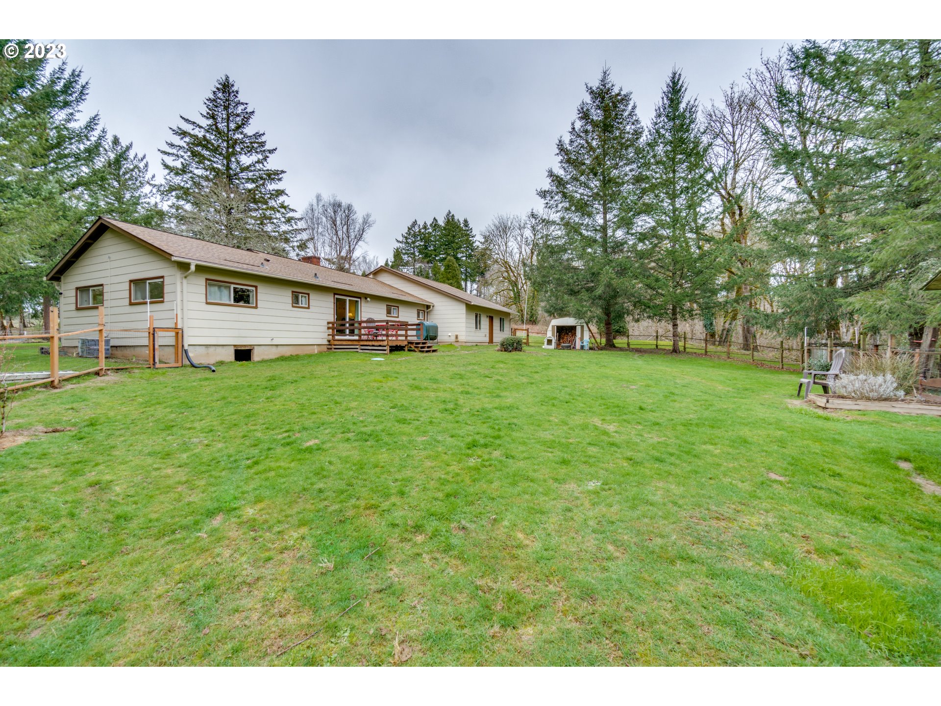 1515 Southeast Northway Road Corbett, OR 97019 - Photo 28 of 32 a view of a house with a big yard and large trees