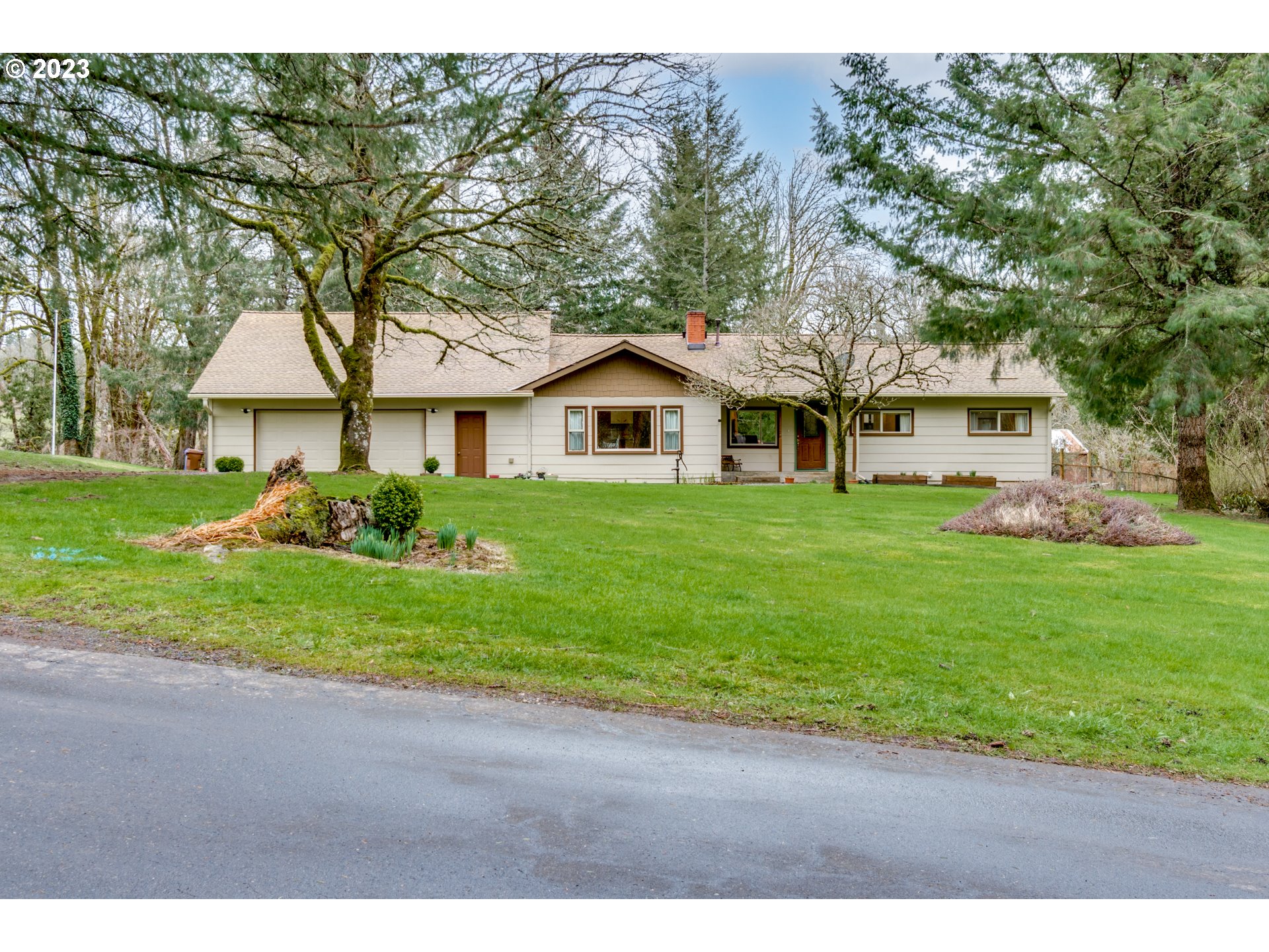 1515 Southeast Northway Road Corbett, OR 97019 - Photo 3 of 32 a front view of a house with a garden