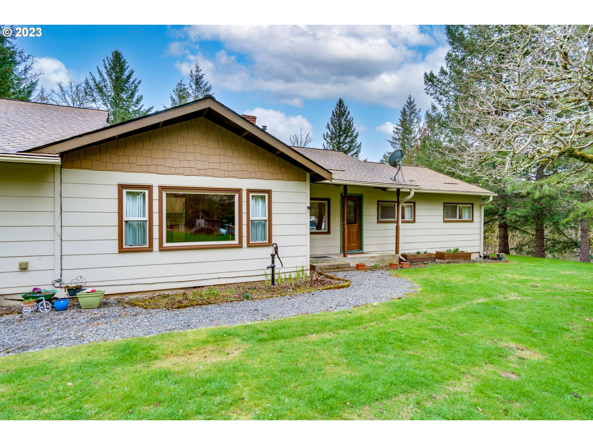 1515 Southeast Northway Road Corbett, OR 97019 - Photo 4 of 32 a view of a house with a yard and sitting area