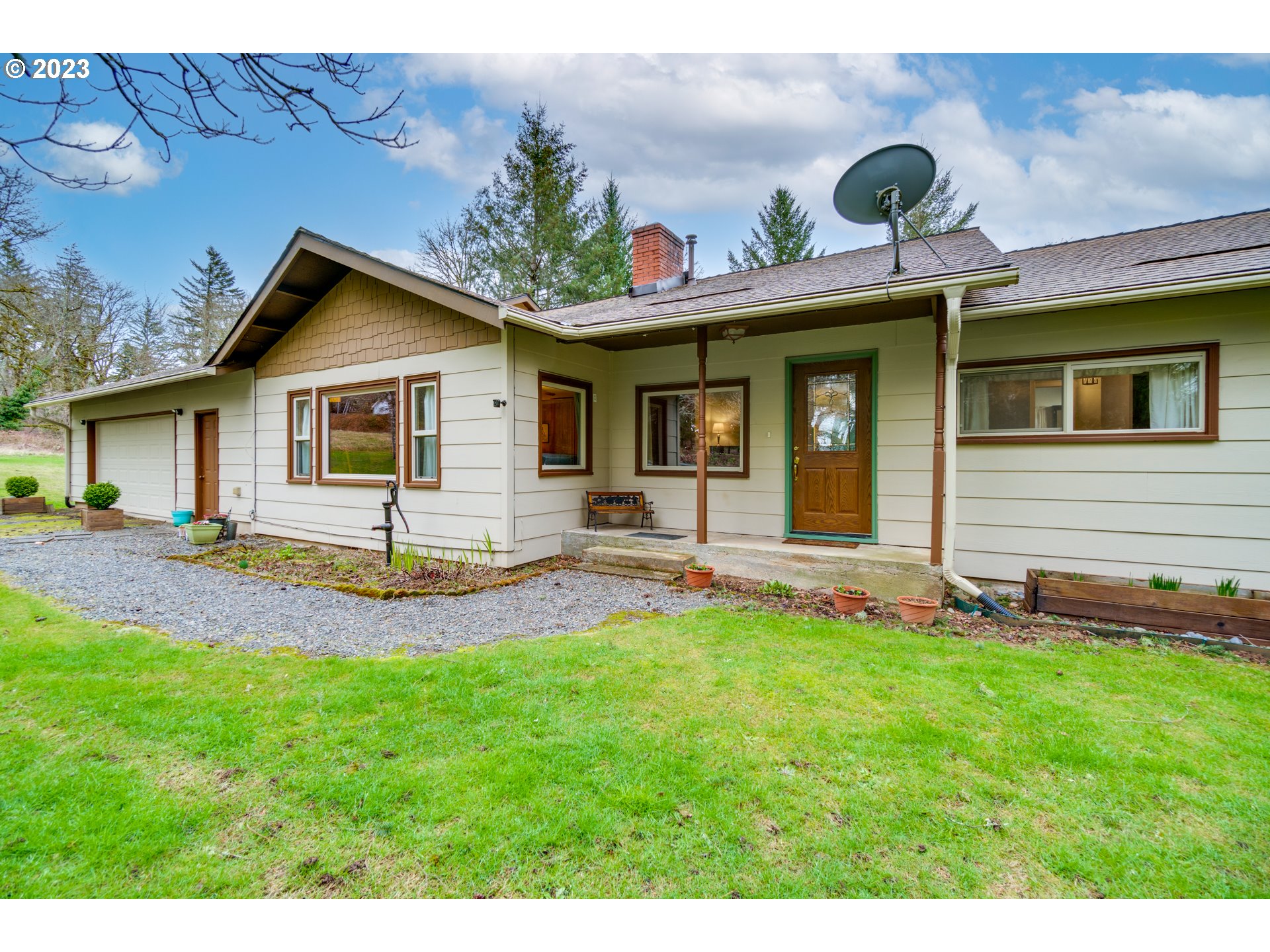 1515 Southeast Northway Road Corbett, OR 97019 - Photo 5 of 32 a front view of a house with a yard and garage