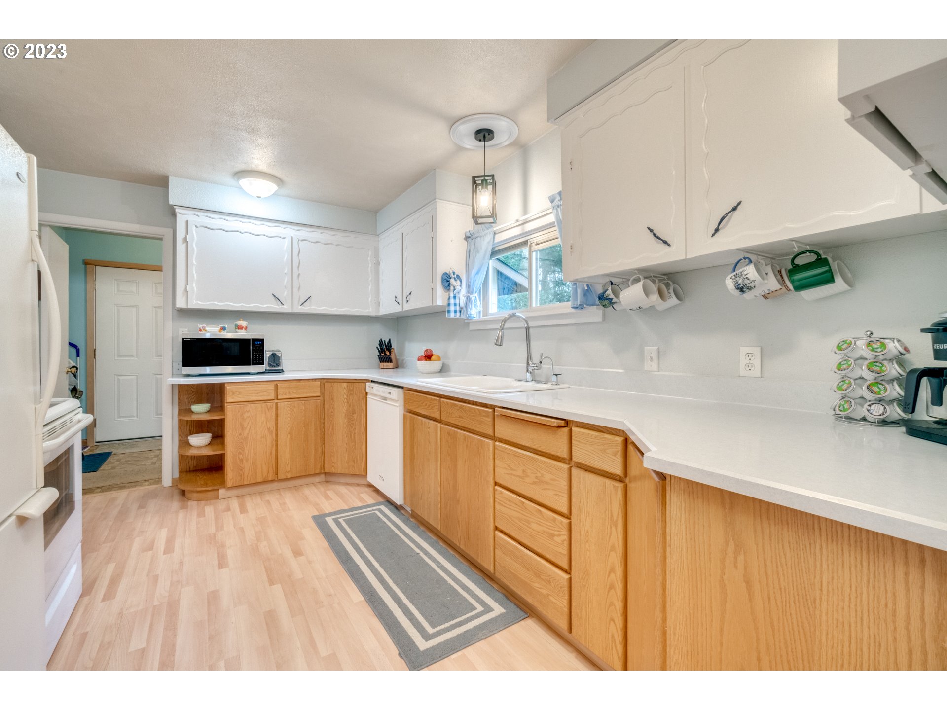 1515 Southeast Northway Road Corbett, OR 97019 - Photo 10 of 32 a kitchen with stainless steel appliances a sink cabinets and wooden floor