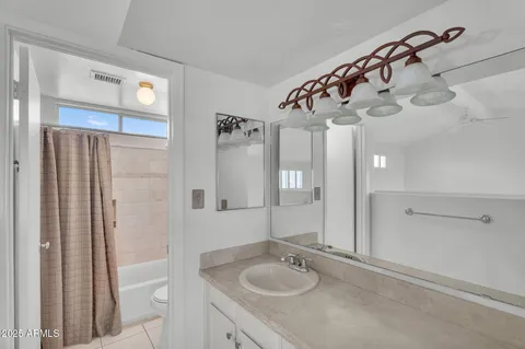 a kitchen with stainless steel appliances a sink cabinets and a window