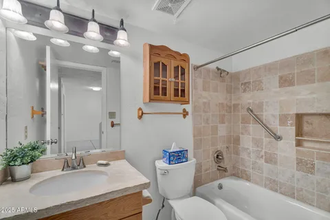 an empty room with chandelier fan