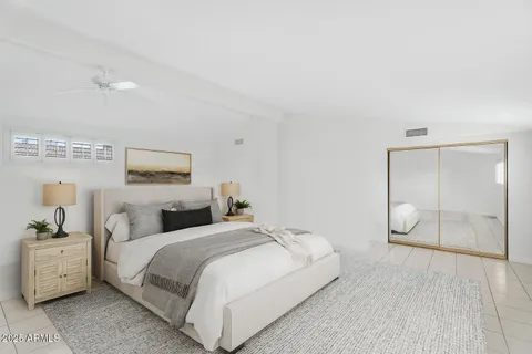 a living room with furniture a fireplace and a potted plant