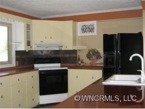 107 Clearwater Road Landrum, SC 29356 - Photo 4 of 12 a kitchen with granite countertop a stove and a refrigerator
