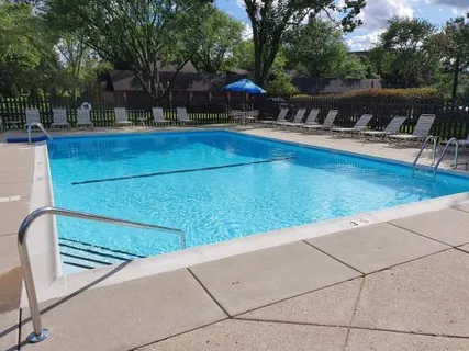 a view of patio with chairs and potted plants