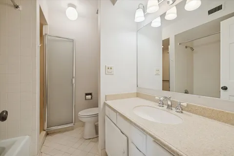 a bathroom with a sink a toilet and a large mirror