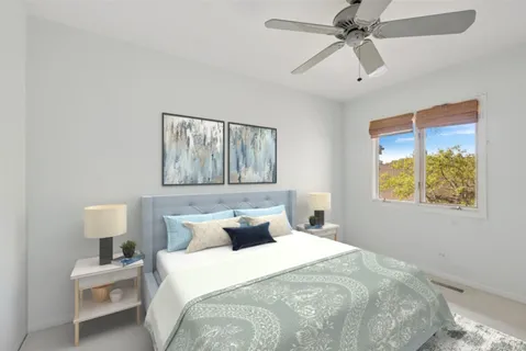 a bedroom with a bed and painting on the wall