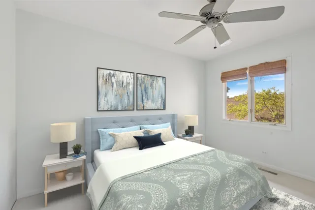 a bedroom with a bed and painting on the wall