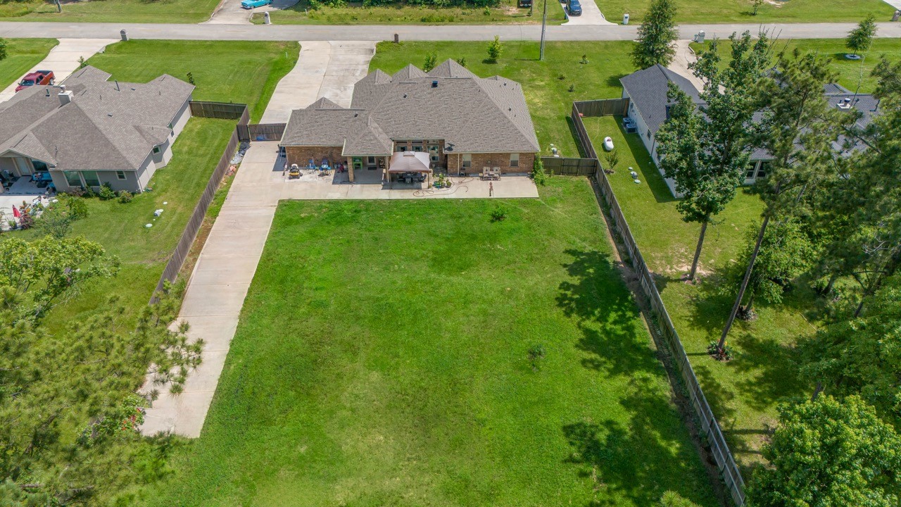 27585 Rio Blanco Drive Splendora, TX 77372 - Photo 34 of 39 Blank canvas to do what you wish in this backyard. Add a pool, a garden, a workshop! Notice the long driveway already added to the backyard.