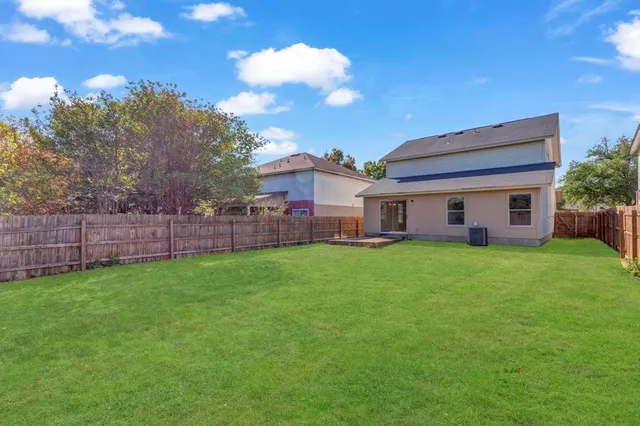 a view of a house with a backyard