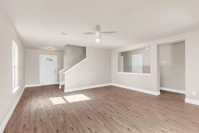 wooden floor in an empty room with a window
