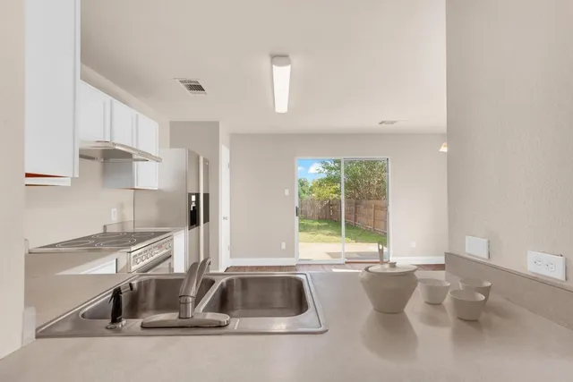 a kitchen with a sink and a window