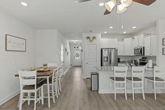 a view of a dining room with furniture and wooden floor