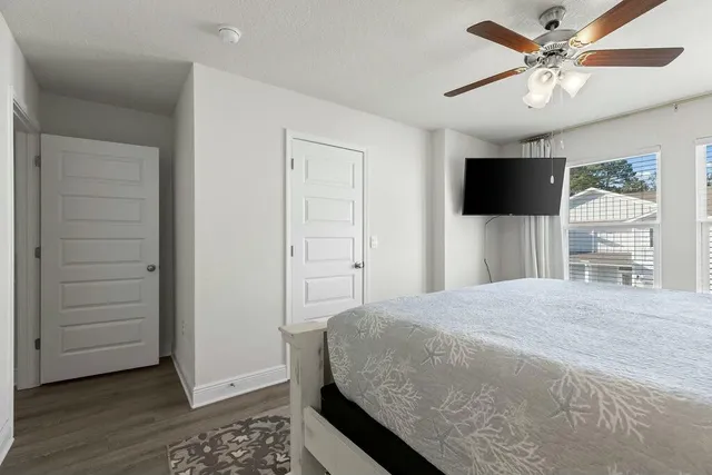 a bedroom with a bed and a flat screen tv