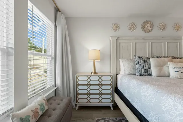 a bedroom with a bed and a night stand