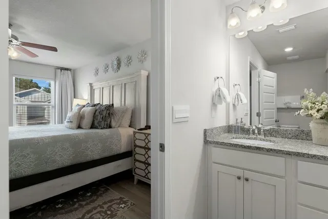 a spacious bedroom with a bed and a dresser