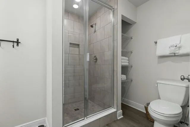 a bathroom with a shower and toilet