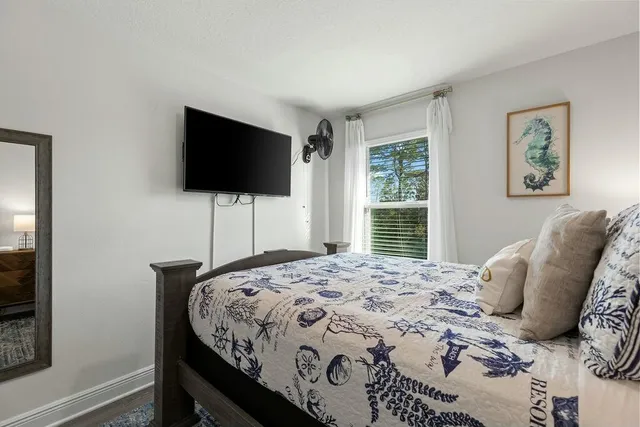 a bedroom with a bed and a flat screen tv