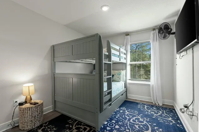 a room with walk in closet and wooden floor