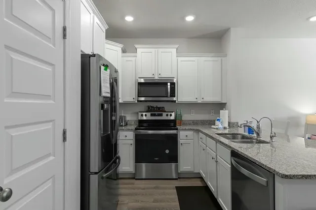 a kitchen with a sink stainless steel appliances and cabinets