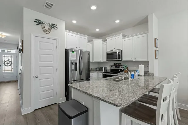 a kitchen with refrigerator and cabinets