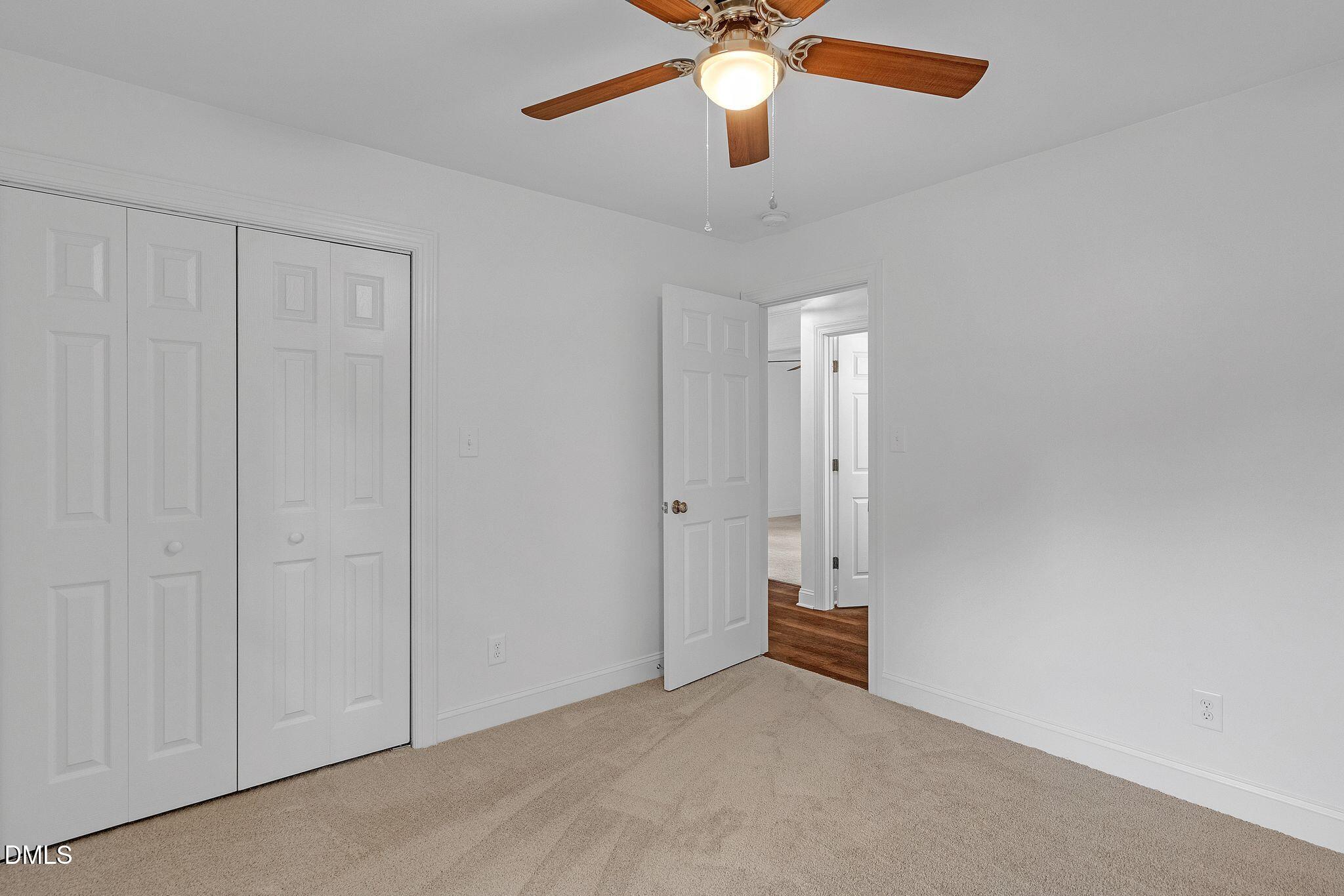 1219 Queen Anne Road Northwest Wilson, NC 27896 - Photo 25 of 26 an empty room with closet and a chandelier fan