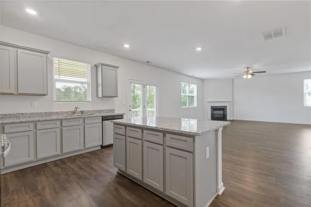 a kitchen with a sink cabinets and wooden floor