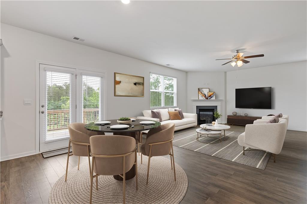 294 Ralph Still Road Dacula, GA 30019 - Photo 17 of 55 a living room with furniture a flat screen tv and a large window
