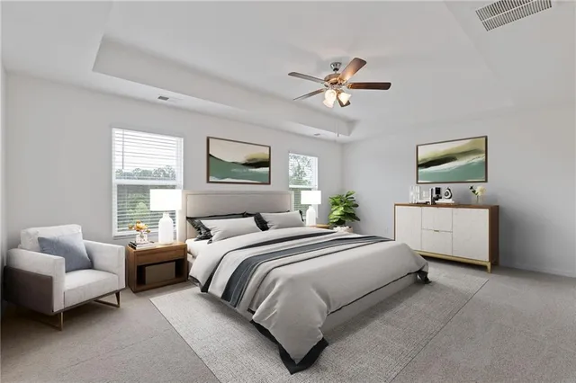 a bedroom with a bed a couch and a window