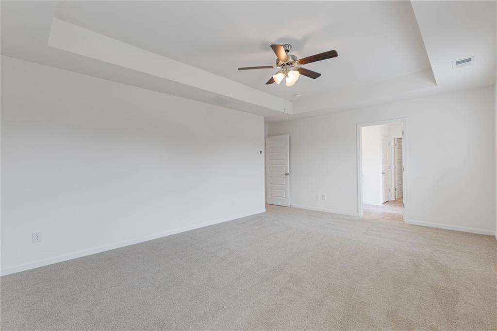 294 Ralph Still Road Dacula, GA 30019 - Photo 29 of 55 a view of an empty room with chandelier fan