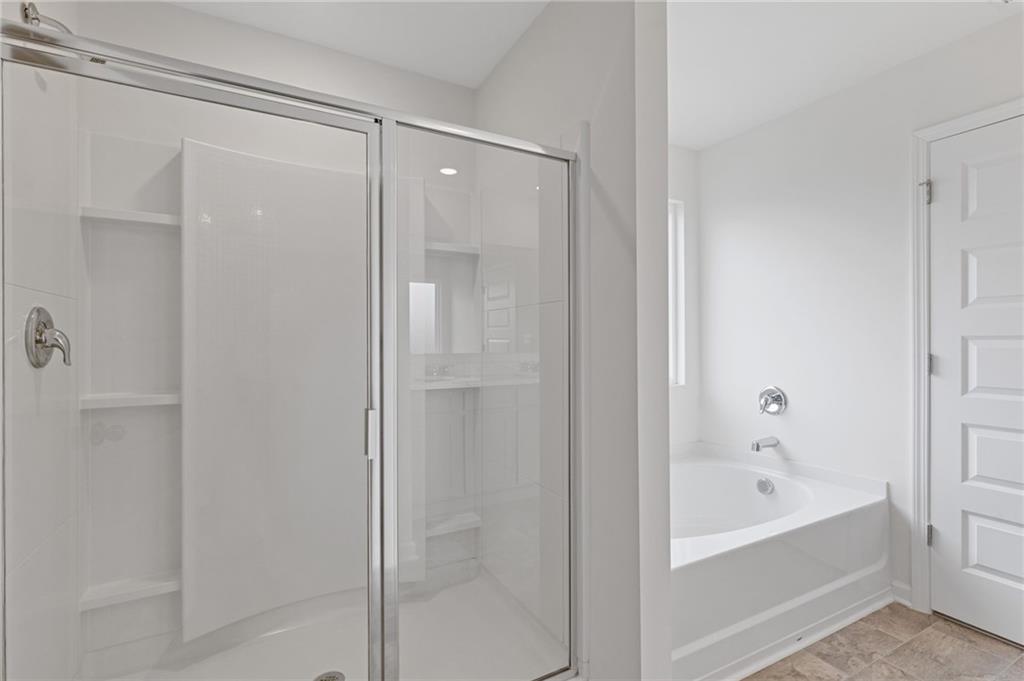 294 Ralph Still Road Dacula, GA 30019 - Photo 34 of 55 a bathroom with a bathtub and shower