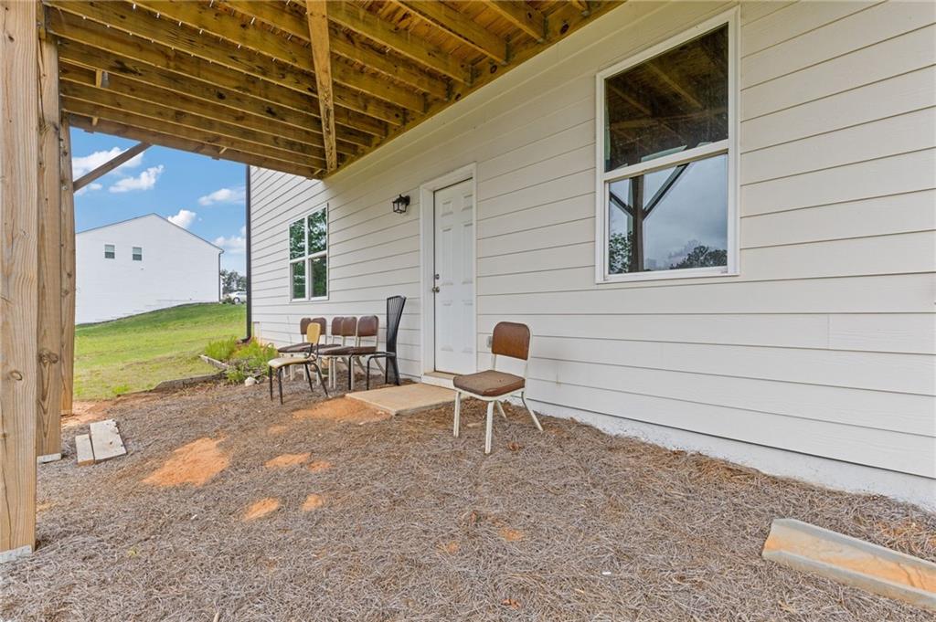 294 Ralph Still Road Dacula, GA 30019 - Photo 47 of 55 a view of a patio with table and chairs and potted plants