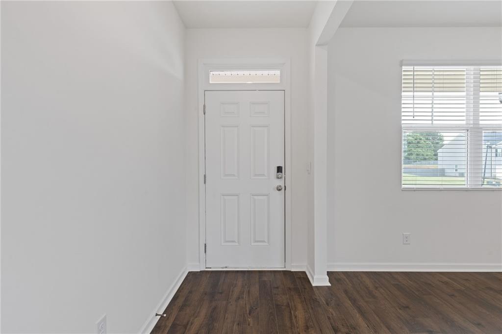 294 Ralph Still Road Dacula, GA 30019 - Photo 7 of 55 an empty room with wooden floor and windows