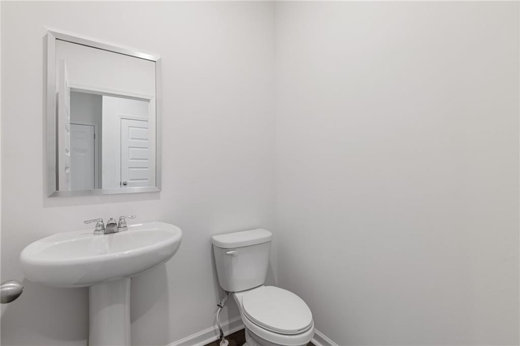 294 Ralph Still Road Dacula, GA 30019 - Photo 10 of 55 a bathroom with a sink a toilet and mirror