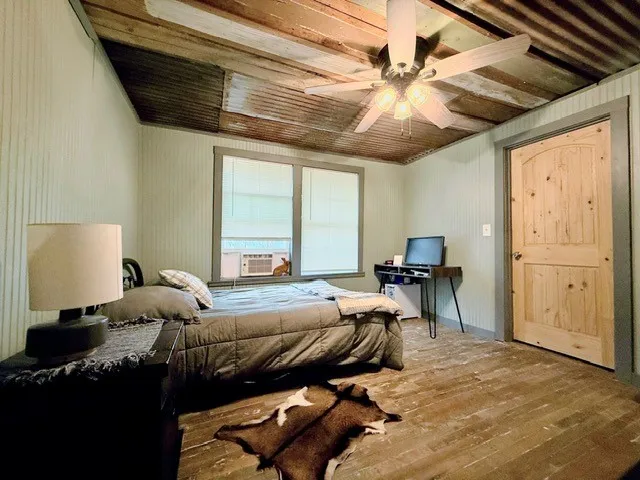 a bedroom with furniture and a window