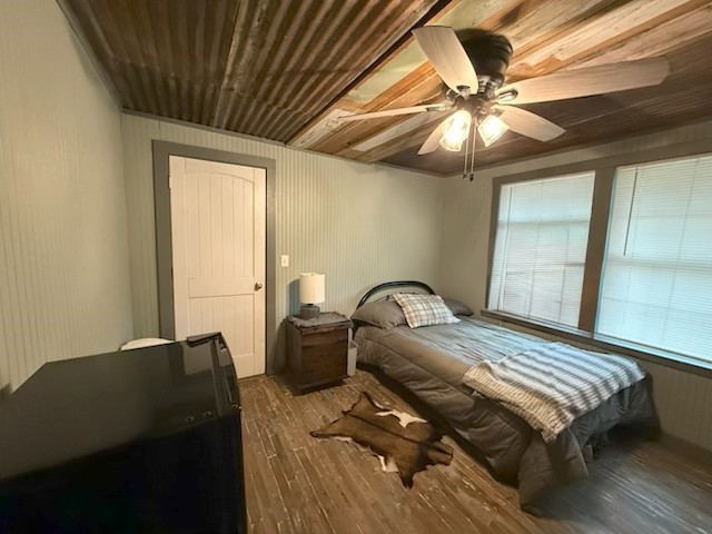 1503 North Hill Street Three Rivers, TX 78071 - Photo 12 of 17 a bedroom with a bed and wooden floor