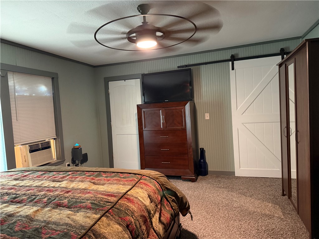 1503 North Hill Street Three Rivers, TX 78071 - Photo 8 of 17 a bedroom with a bed and a chandelier