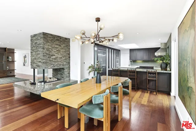 a kitchen with granite countertop a counter space dining table and stainless steel appliances