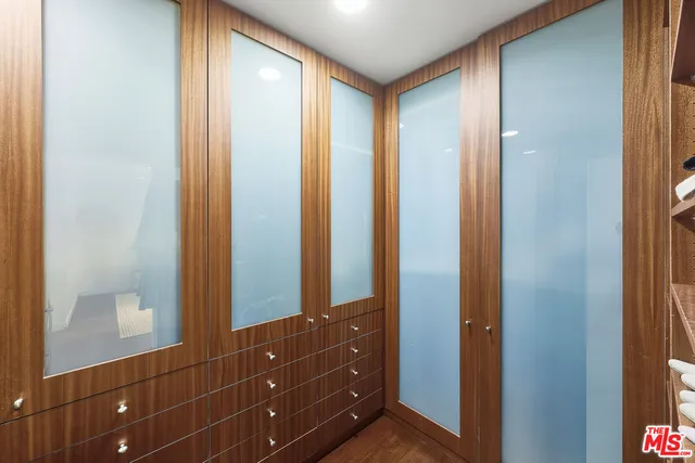 a bedroom with a large bed and a large window