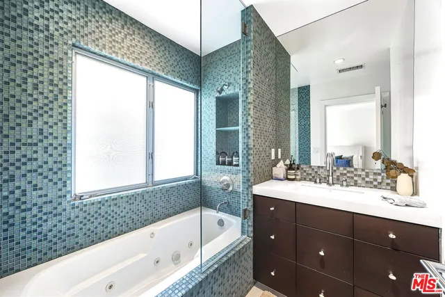a living room with furniture a rug and a flat screen tv