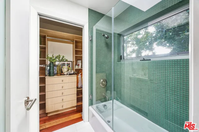 a kitchen with a sink and wooden floor