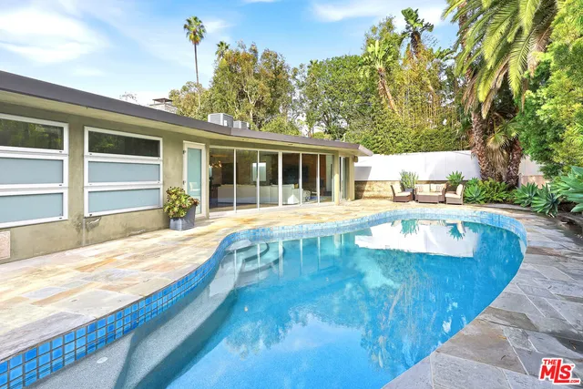 a view of a swimming pool with a patio
