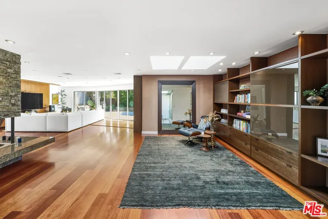 a living room with fireplace furniture and a floor to ceiling window