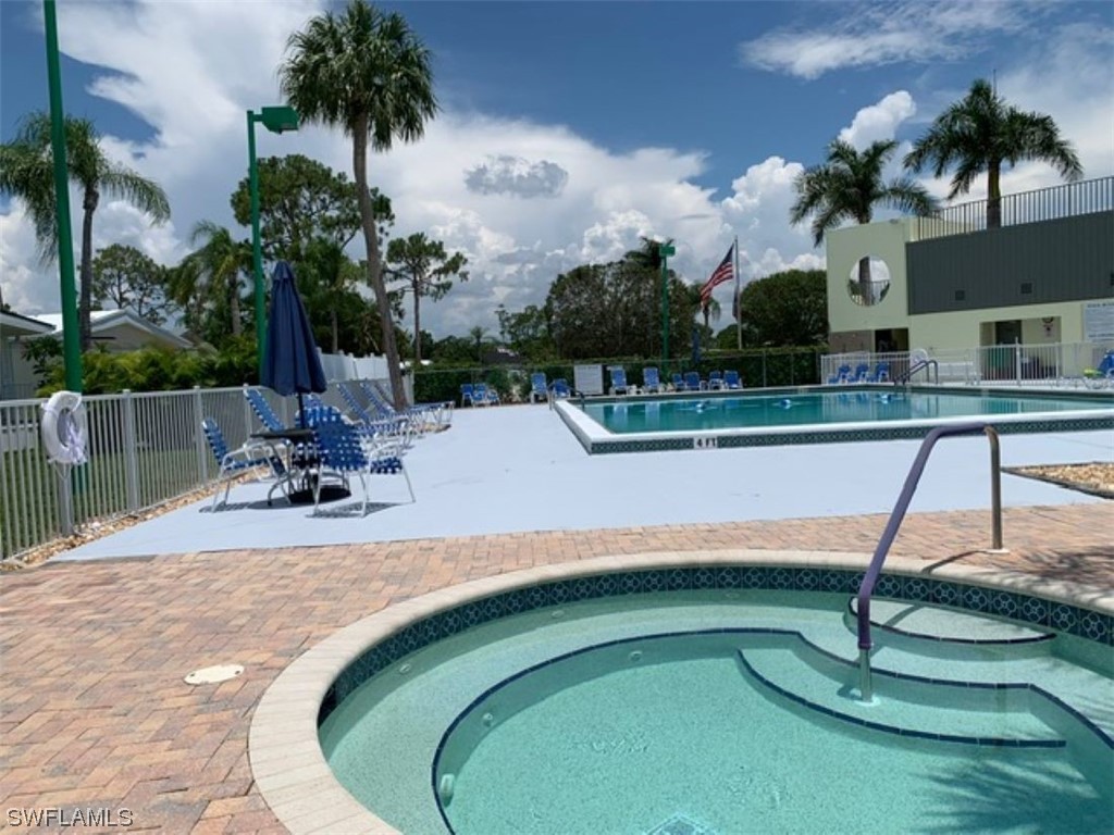 10844 Ani Circle Estero, FL 33928 - Photo 21 of 24 a view of a swimming pool with a patio and a garden