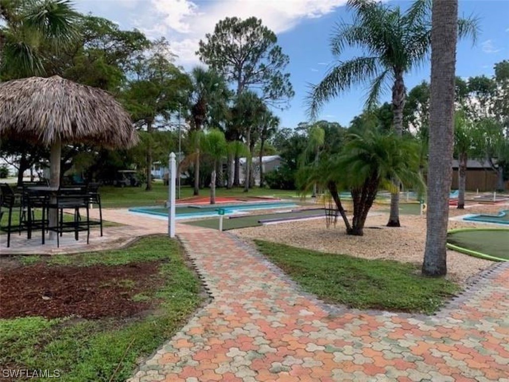 10844 Ani Circle Estero, FL 33928 - Photo 23 of 24 a view of a park with swings and slides